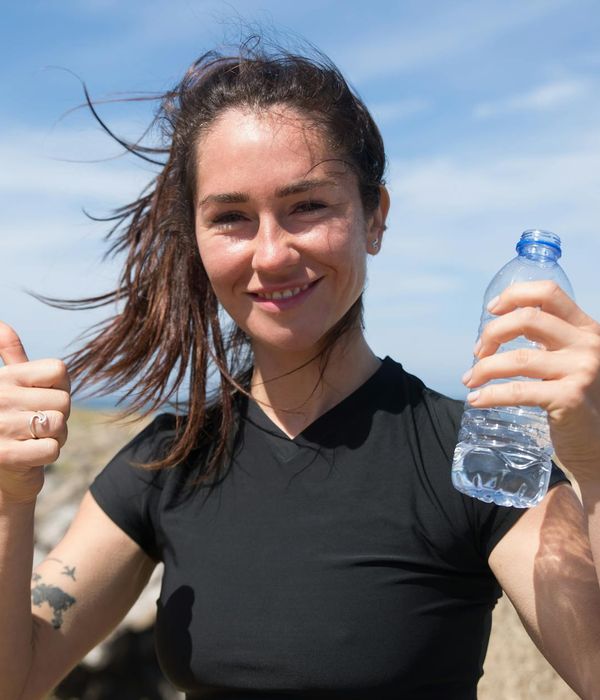 Energetic woman smiling during a light outdoor exercise.