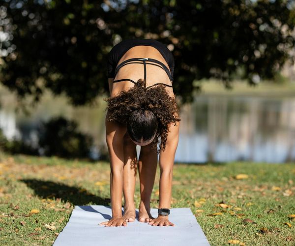 Person stretching by a window, enjoying the morning sun.
